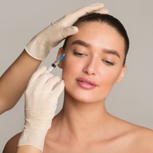 Woman with perfect skin receiving botox injection